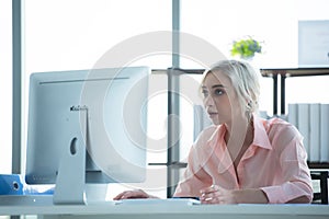 Businesswoman caucasian using  computer to work with financial data in the modern office,