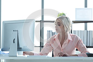 Businesswoman caucasian using  computer to work with financial data in the modern office, relax and rest time after work.