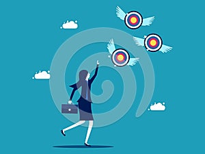 Businesswoman chasing a target that flies away from him. Failed goals and finding goals. business concept