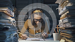 Businesswoman checking a contract with a magnifier