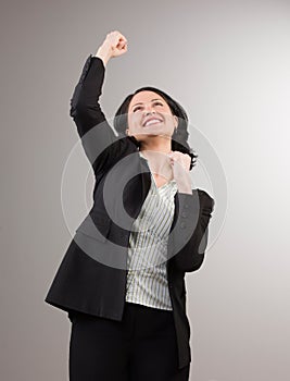 Businesswoman cheering and celebrating her success