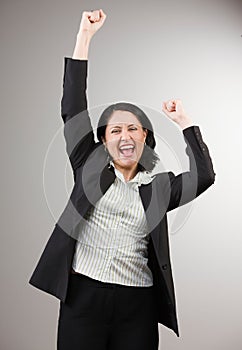 Businesswoman cheering and celebrating her success