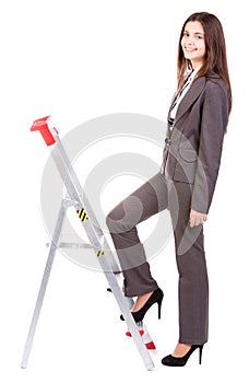 Businesswoman climbing ladder