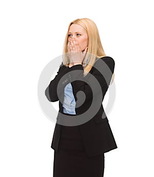 Businesswoman closing her mouth with hands