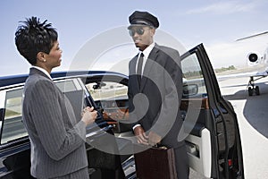 Businesswoman Communicating With Driver On Airfield photo