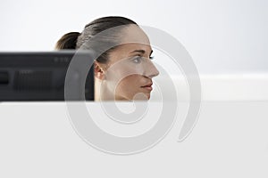 Businesswoman At Computer Desk Looking Away