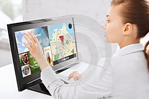 Businesswoman with computer touchscreen in office