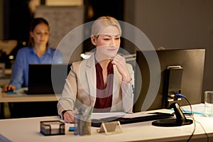 Businesswoman at computer working at night office