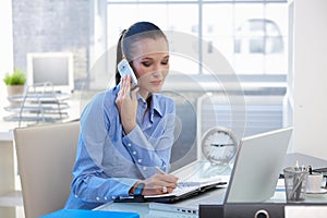 Businesswoman concentrating on phone call