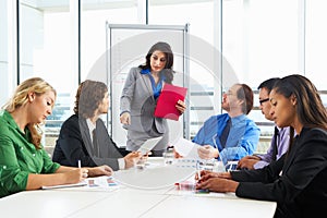 Businesswoman Conducting Meeting In Boardroom