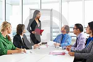 Businesswoman Conducting Meeting In Boardroom