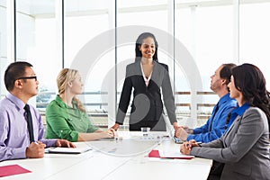 Businesswoman Conducting Meeting In Boardroom