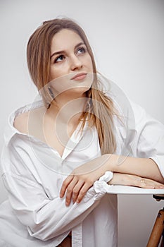 Businesswoman confident portrait. Fashion shoot of young sexy in white studio street style. Fashion photo. Caucasian