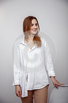 Businesswoman confident portrait. Fashion shoot of young sexy in white studio street style. Fashion photo. Caucasian