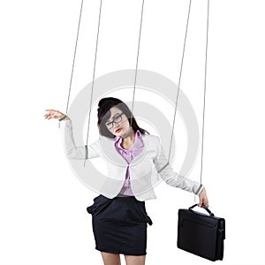 Businesswoman controlled by strings isolated