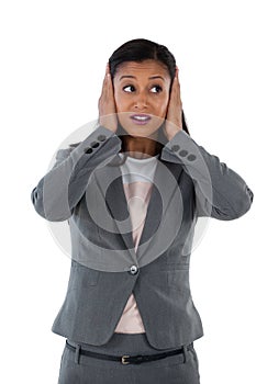 Businesswoman covering her ears