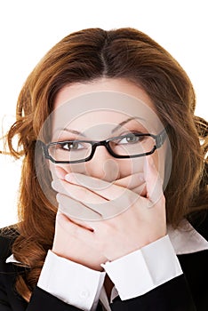 Businesswoman covering her mouth because of shame