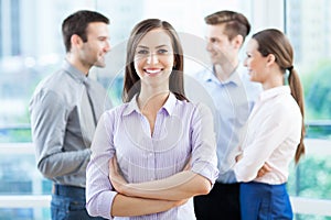 Businesswoman with coworkers in background