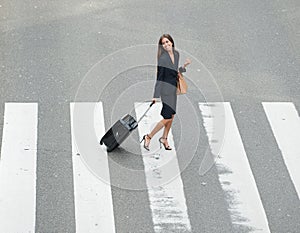 Businesswoman crossing street at crossway