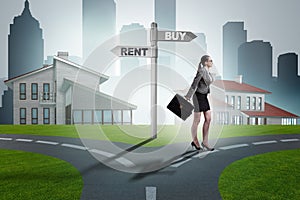 The businesswoman at crossroads betweem buying and renting