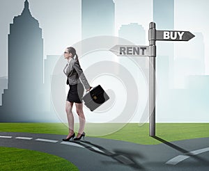 Businesswoman at crossroads betweem buying and renting