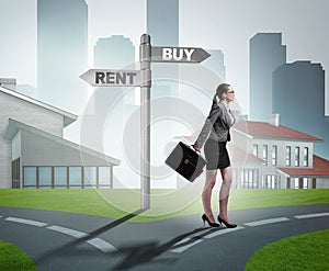 Businesswoman at crossroads betweem buying and renting