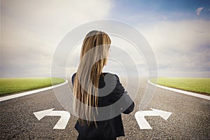 Businesswoman at a crossroads. She chooses the correct way. Concept of decision in business