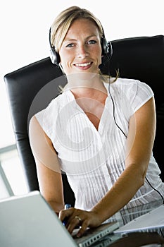 Businesswoman at desk with headset