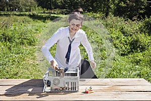 Businesswoman destroys the computer with a hammer