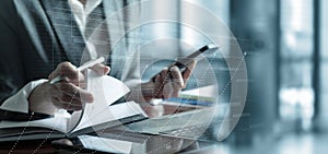 Businesswoman developing a plan at her desk in a modern office