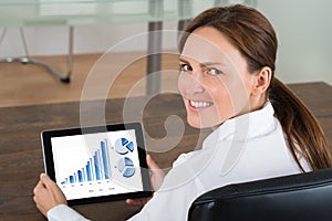 Businesswoman With Digital Tablet Showing Graphs