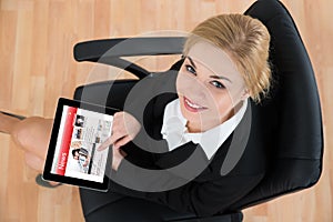 Businesswoman With Digital Tablet Showing News