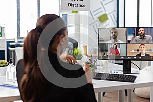 Businesswoman discussing with remote business team during online videocall