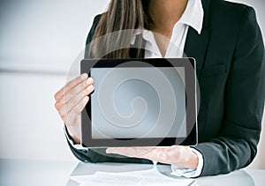 Businesswoman displaying a blank tablet