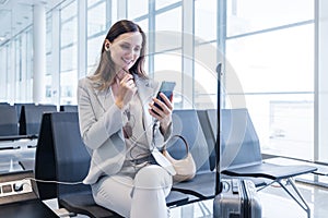 businesswoman doing a calls while at gate of airport