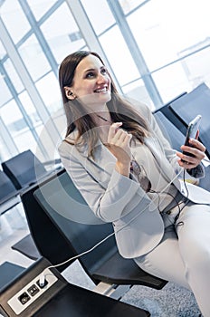 businesswoman doing a calls while at gate of airport