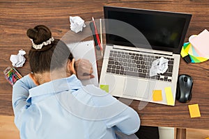 Businesswoman doing head down on desk