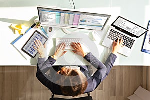 Businesswoman Doing Multitasking Work In Office