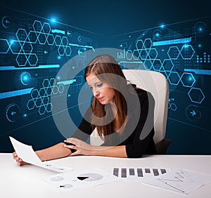 Businesswoman doing paperwork with futuristic background