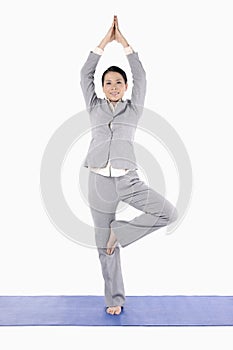 Businesswoman doing yoga. Conceptual image