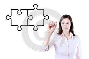 Businesswoman drawing a Blank Puzzle on the screen. Isolated on white.