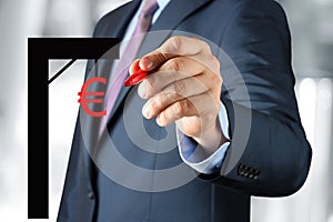 Businesswoman drawing a virtual gibbet with euro by a red pen photo