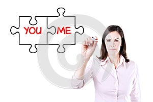 Businesswoman drawing a You and Me puzzle love concept on the virtual screen.