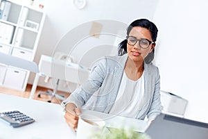 Businesswoman drinking coffee or tea at office