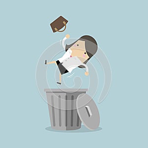 Businesswoman dropped into trashcan layoff concept.