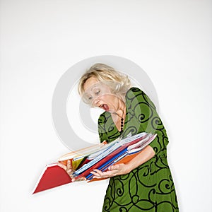 Businesswoman dropping folders