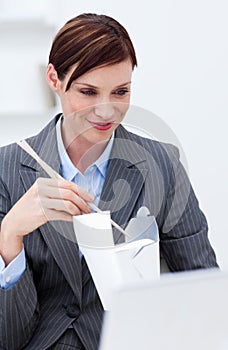 Businesswoman eating chinese food with chopstick