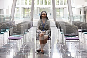 Businesswoman In Empty Auditorium Preparing To Make Speech