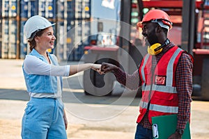 Businesswoman and engineer join hands to work success loading Containers box from Cargo freight ship for import export. Freight