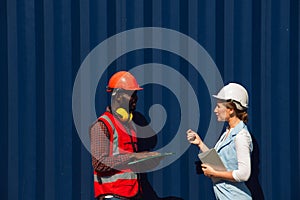 Businesswoman and engineer talking and checking loading Containers box from Cargo freight ship for import export. shipping in